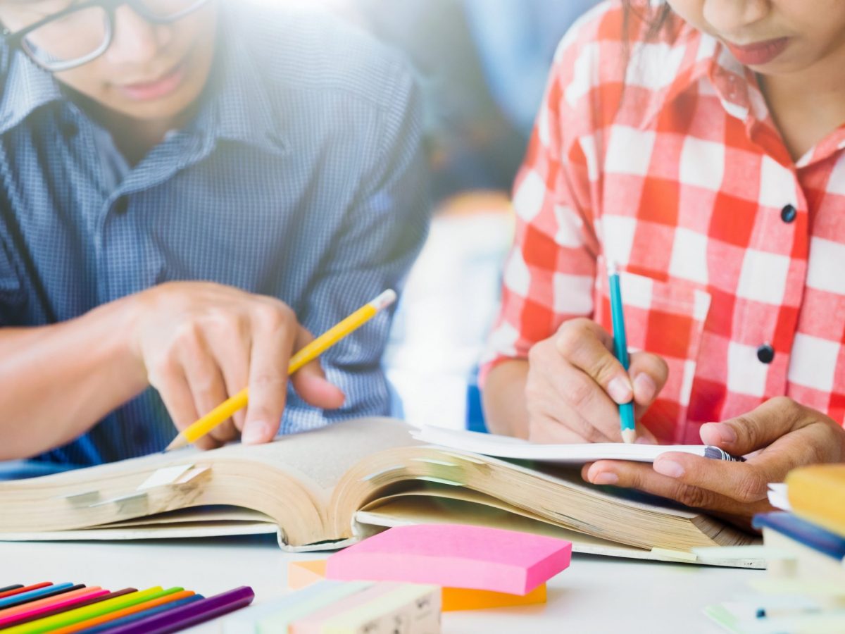 Young students campus helps friend catching up and learning.